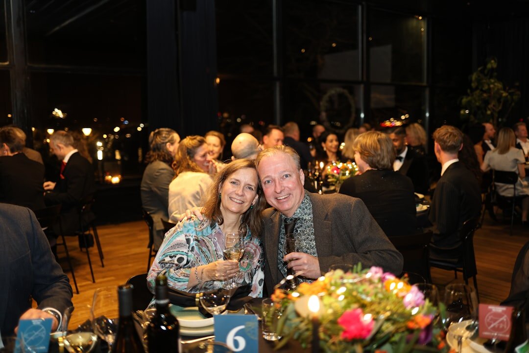 Elegant couple laughing together at an evening gala
